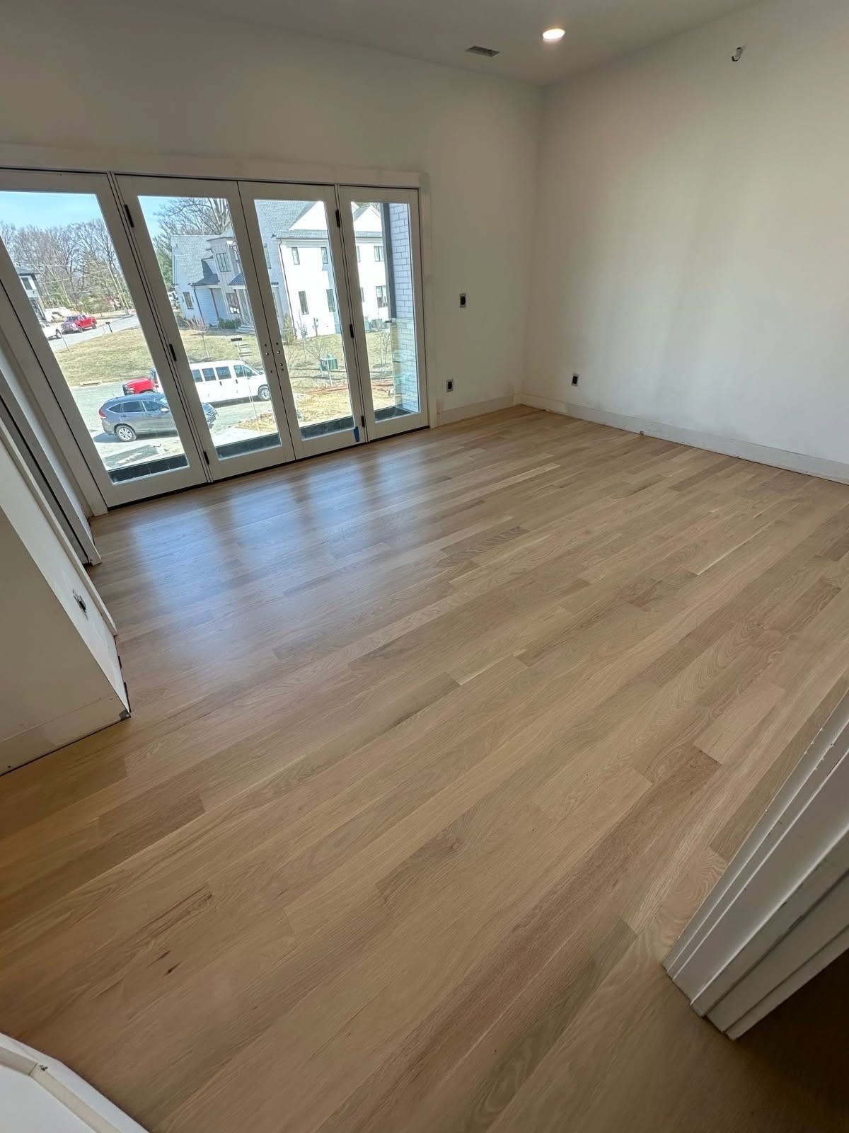 Natural wide-plank oak flooring installed in a bright Colorado living room